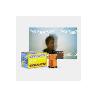 A Grafx hot ink film product display featuring a yellow and blue 25mm film box, an orange film roll, and a brown film strip in front of a blurred demonstration photo with white graphic overlays.