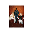 Three models pose in a stylized studio setup with a textured orange-brown wall, gold web-like lines, and a dark patterned floor. One model wears a shiny cream satin top and white pants, seated on a bench.