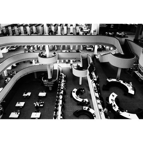 Black and white interior of a modern building with multiple levels and staircases.