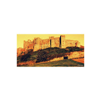 Stone castle on a hill rendered in dramatic red, orange, and yellow tones using HARMAN Red 125 redscale 35mm film.
