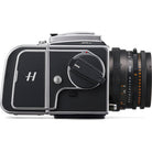 A black and silver Hasselblad 500Cw medium format camera with an attached black lens, shown from a side profile on a white background.