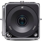 A Hasselblad medium format camera shown from the front, featuring a large black lens with white text and a silver-toned metal body, isolated on a white background.