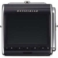 A Hasselblad medium format camera body shown from the back, featuring a large black rear screen, silver metal side frames, and the 'HASSELBLAD' brand name in gold lettering above the screen.