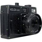 Black Holga 135FC toy camera with a glittery finish, built-in flash, and a 47mm optical lens on a white background.