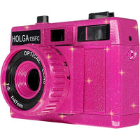 Sparkling hot pink Holga 135FC toy camera with a 47mm optical lens and built-in flash against a white background.