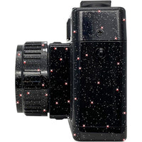 Side view of a black Holga 135FC toy camera featuring a glossy finish with a sparkling, star-like glitter pattern.