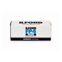 Ilford FP4 Plus Black & White Film box packaging, featuring a white box with black and blue branding, on a clean white background.