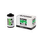 An Ilford HP5 Plus black and white film canister standing next to its original white, black, and green retail box on a clean white background.