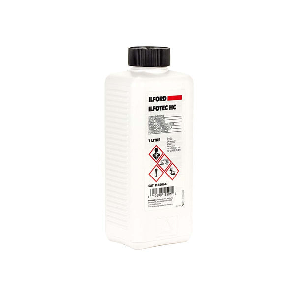 A white plastic bottle of Ilford ILFOTEC HC oil with a black ribbed cap, shown on a plain white background.