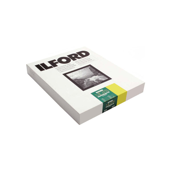A boxed Ilford-Multigrade-FB-Classic-Matte-Paper-1 with bold black 'ILFORD' branding, a black-and-white sample print, and a green and yellow paper band around the side.