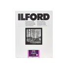 A pack of Ilford Fine Grain photographic paper, featuring a white package with black text, a black-and-white sample photo of a tractor in a forest, and a purple MGRC Deluxe label at the bottom.