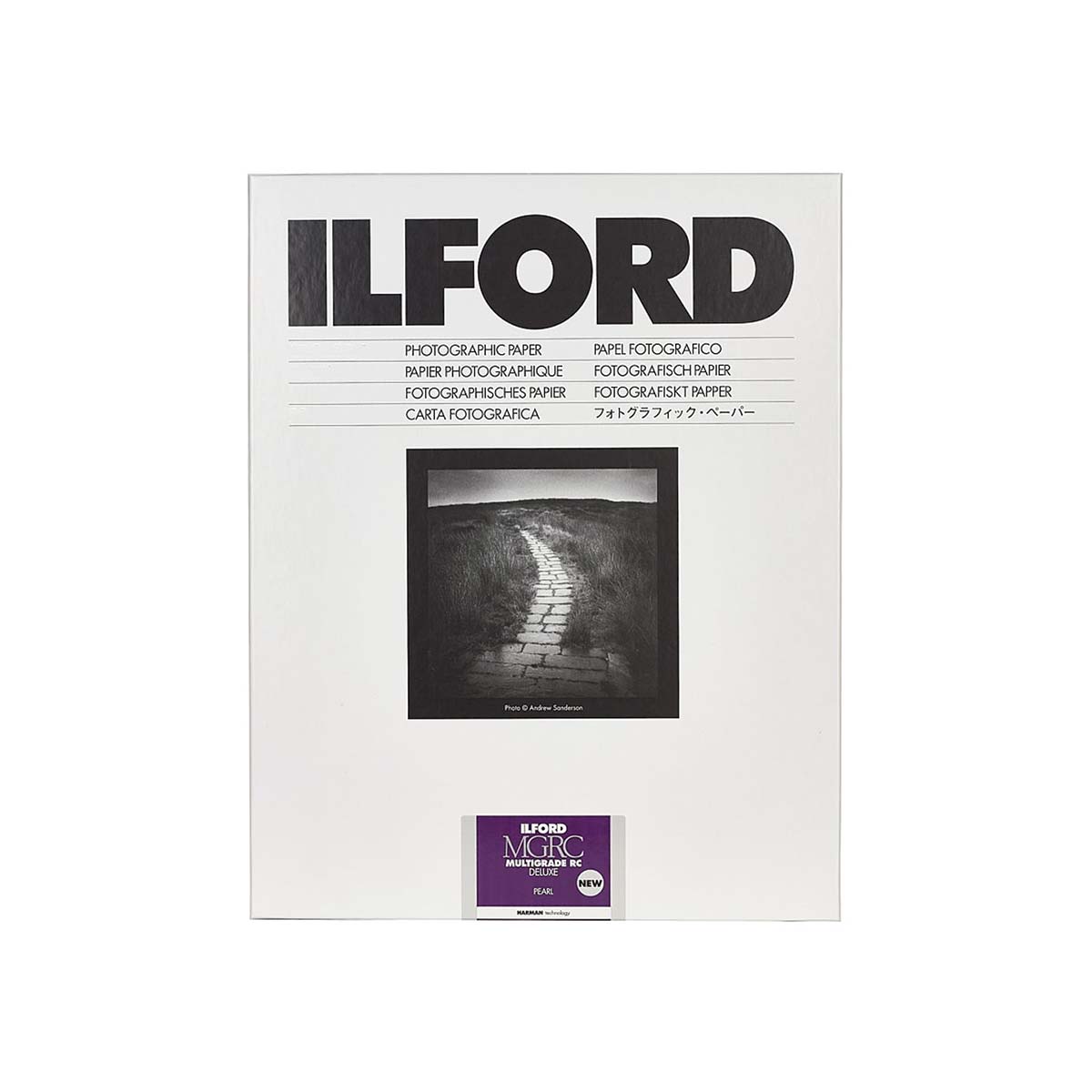 A pack of Ilford B&W (black and white) fine grade photographic paper, featuring a white cover with bold black text, a central black and white sample photograph of a path, and a purple Ilford logo sticker at the bottom.