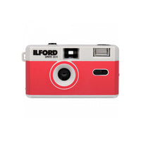 A retro-style Ilford Sprite 35mm film camera in red and white, featuring the Ilford brand name and 'SPRITE 35-II' printed on the front.