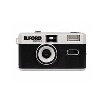 An Ilford Sprite 35-II disposable camera with a black and white color scheme, shown from the front against a plain white background.