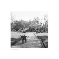 Black and white landscape shot on Kentmere Pan 200 120 film showing a garden path with a wheelbarrow and gardener.