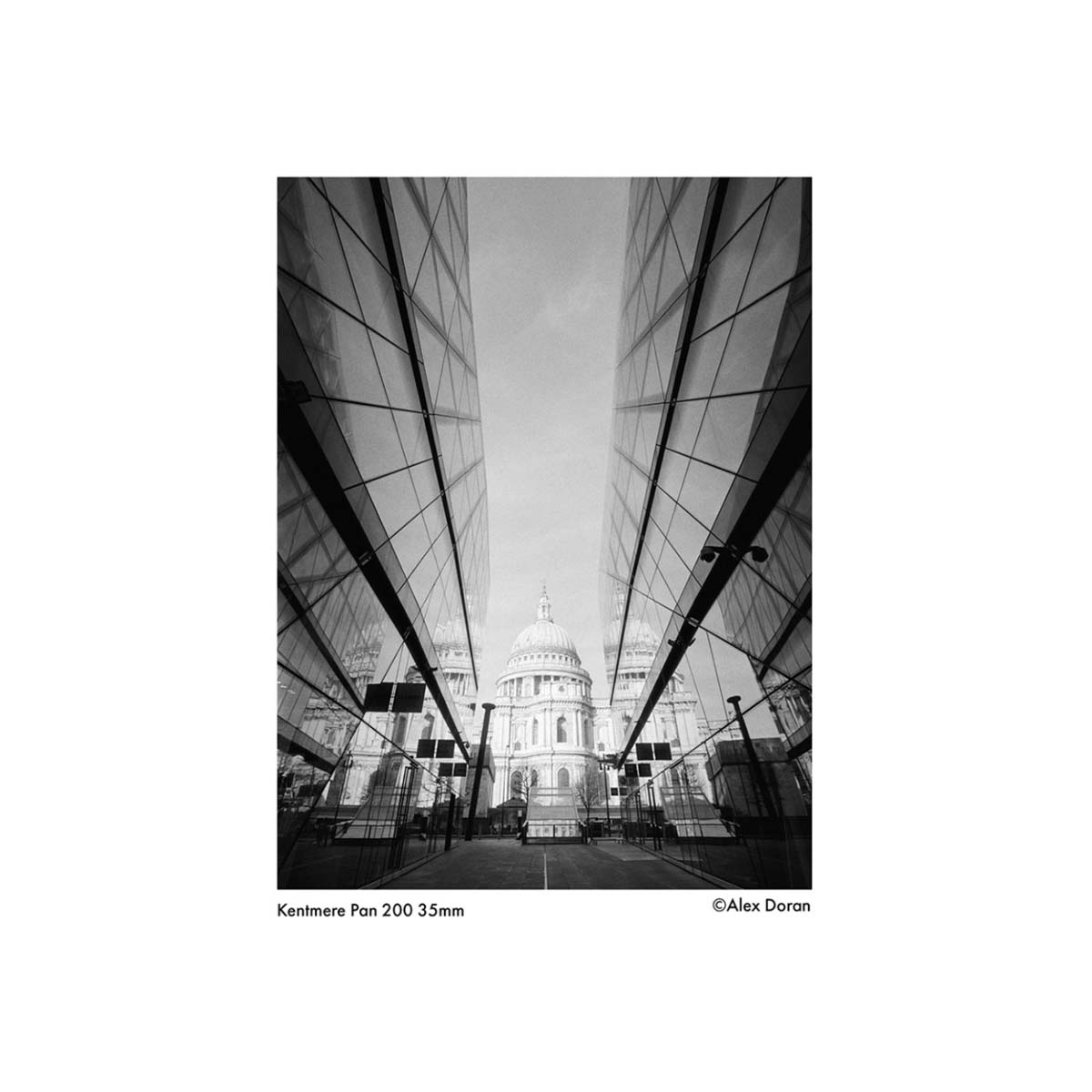 Black and white architectural shot of St. Paul's Cathedral framed by modern glass buildings, captured on Kentmere Pan 200.