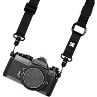 Black camera with a strap on a white background