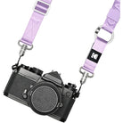 Camera with a purple strap on a white background