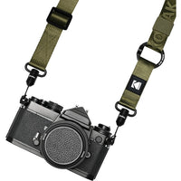 Camera with a green strap on a white background