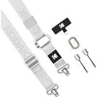 A Kodak camera strap in light gray with silver metal hardware, shown alongside a black branded keeper, a carabiner, and two small silver tools on a plain white background.