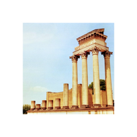 A photograph featuring a columned building with a dome, possibly a church or a similar architectural structure, against a light blue sky.