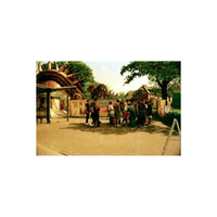 A vintage photograph of a crowd of people standing in front of a large, whimsical dragon-themed entrance at what appears to be a fair or amusement venue. The scene has a strong warm, yellowed, and grainy aesthetic typical of older film or scan scans.