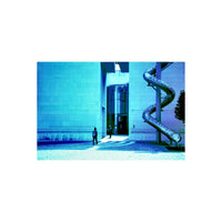 Modern building with a spiral slide, captured with the distinct blue and purple color shifts of KONO! Donau II film.