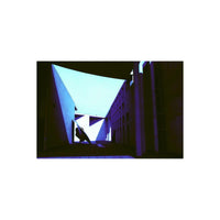 Modern architecture captured on KONO! Donau II film with deep blue and purple color shifts and high-contrast shadows.