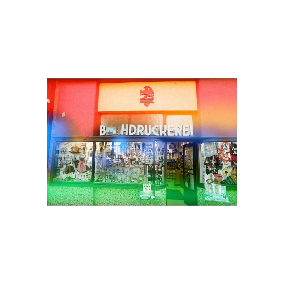 Storefront with KONO! Galaxy 200 film's signature multicolored light leaks and bold color shifts.