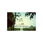 Classical stone temple in a park, captured on 35mm film with moody, cool-toned colors and a vintage experimental aesthetic.