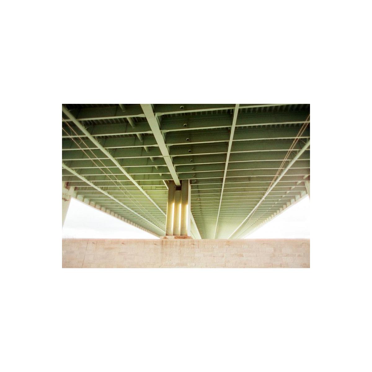 Low-angle shot of a green metal bridge structure with soft, vintage-style color tones captured on KONO! Smile 200 film.
