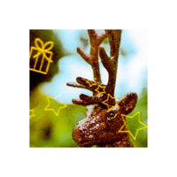 A close-up of a brown reindeer head with antlers, overlaid with yellow line drawings of stars, candy canes, and gift boxes against a blurred green and blue background.