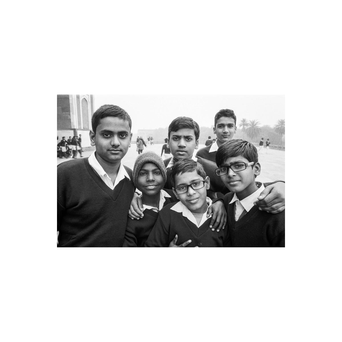Black and white portrait of five young students in school uniforms posing together outdoors.