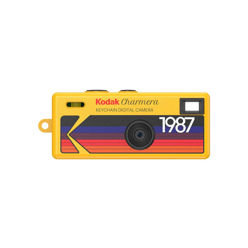 Yellow Kodak Charmera keychain digital camera with a retro 1987 striped graphic design and a compact rectangular body.