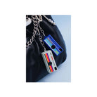 Two Kodak Charmera keychain digital cameras in blue and grey with retro stripe designs attached to a black leather bag.