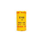 A single roll of Kodak E100 ISO 100 film wrapped in its signature bright yellow protective paper packaging, shown against a plain white background.