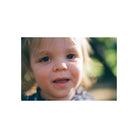 Close-up portrait of a child with warm, natural skin tones and soft focus, captured on Kodak Gold 200 color film.