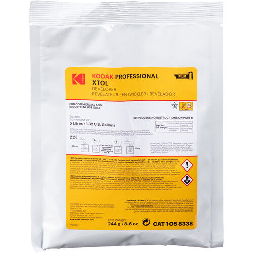 A white plastic bag of Kodak Professional XTOL Developer Reveal Developer chemical solution, featuring a large yellow and white label with product details and safety icons.