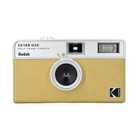 Kodak Ektar H35 half-frame film camera in sand yellow with a silver top, featuring a built-in flash and fixed-focus lens.