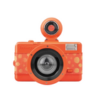 An orange retro-style compact camera with a circular pop-up viewfinder, black lens, and gold circular dot pattern on the body, shown against a light gray background.