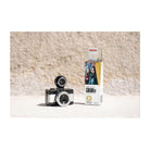 LomoChrome Color '92 110 film box next to a compact 110 film camera on a textured stone surface.