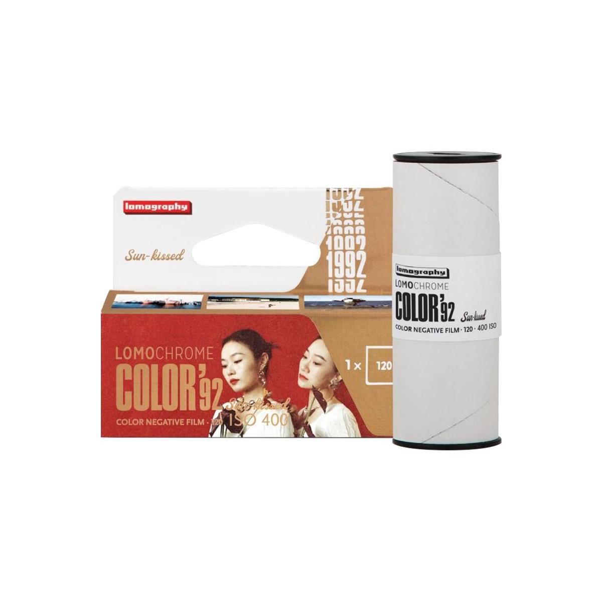 Lomography Color 32 film roll and its retail packaging, featuring a white spool with a black top and bottom and a cardboard-and-white box with red and brown panels and model imagery.