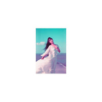Woman in a white dress on a pier, captured with LomoChrome Purple film featuring teal skies and violet color shifts.