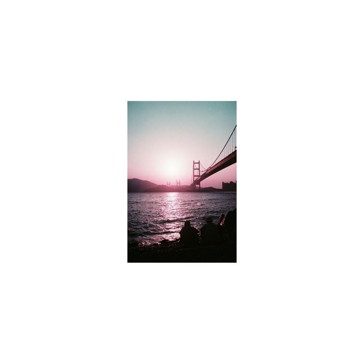 Golden Gate Bridge silhouette captured on 35mm film with dreamy purple, plum, and red color shifts.
