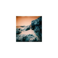 Rocky landscape shot on LomoChrome Turquoise 120 film with dramatic blue rock formations and a golden orange sky.