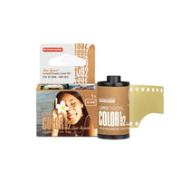 A package of LomoChrome Color '92 Sun-kissed 35 mm ISO 400 film with a photograph of a woman on the packaging.