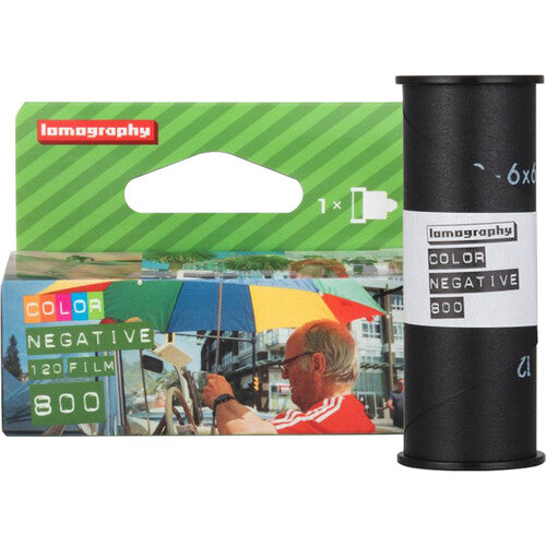 Lomography Color Negative 800 film shown with its green retail packaging and a black film roll on a white background.