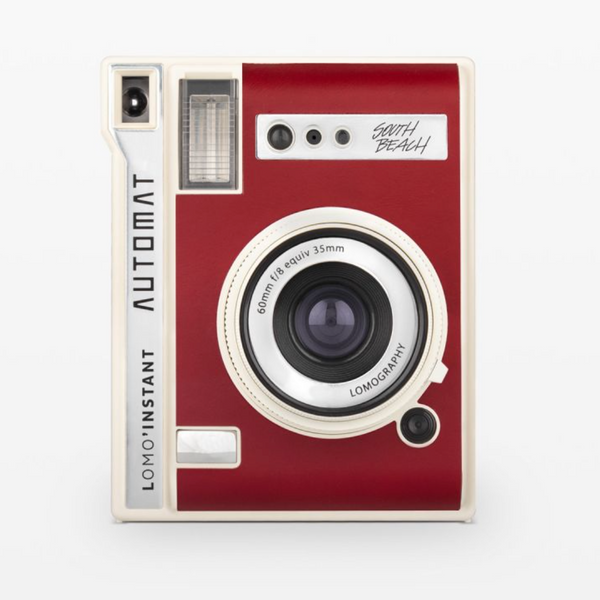 Red and white instant camera on a white background