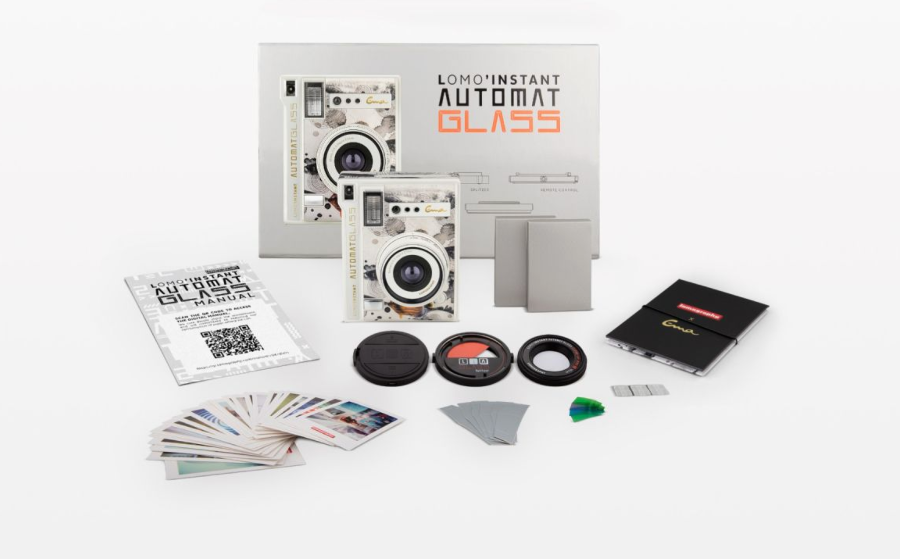 Lomo Instant Automat Glass film camera kit with accessories including a camera body, lens, filters, card holder, and instruction booklet on a white background.