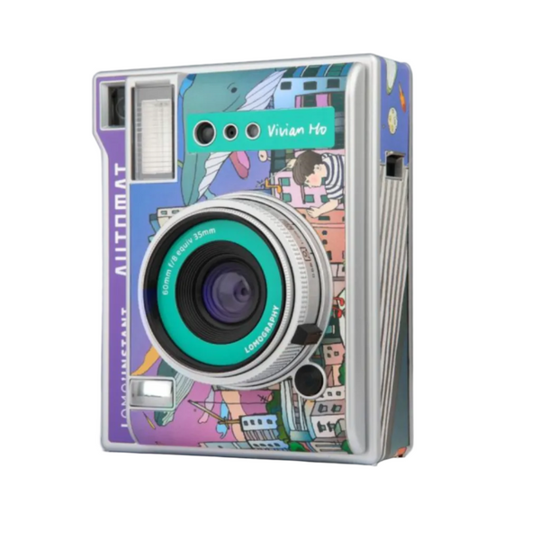 A vintage-style instant camera with a colorful illustrated wrap featuring a purple and teal cityscape design, shown on a clean white background.